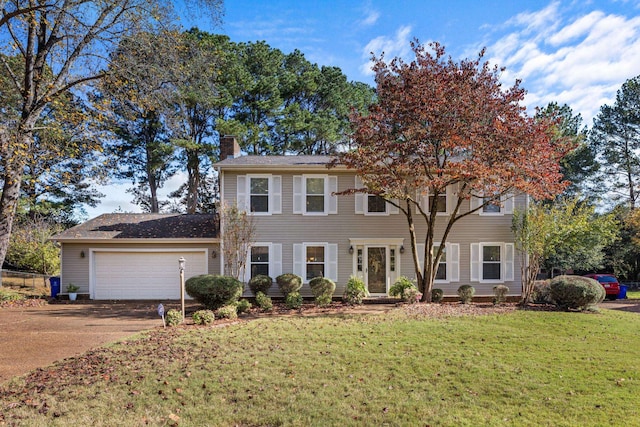 colonial-style house with a front yard and a garage