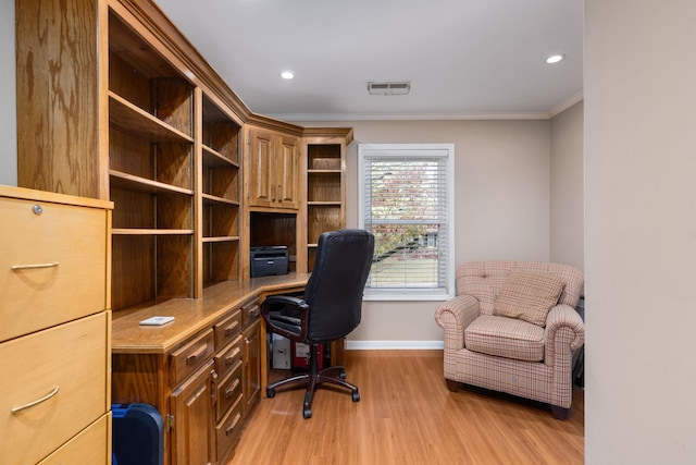 home office featuring light hardwood / wood-style flooring and crown molding