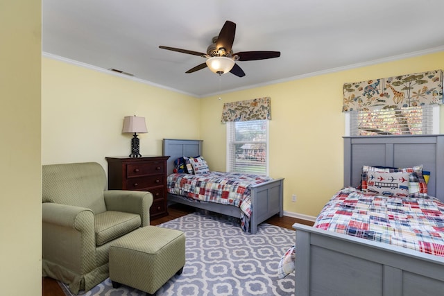 bedroom featuring ceiling fan, dark hardwood / wood-style floors, and crown molding