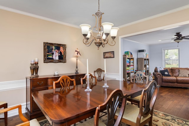 dining space featuring wood-type flooring, ceiling fan with notable chandelier, and ornamental molding