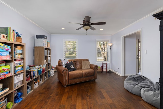 living room with ornamental molding, ceiling fan, and dark wood-type flooring