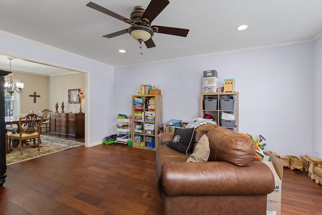 sitting room featuring crown molding, dark wood-type flooring, and ceiling fan with notable chandelier