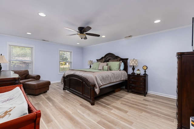 bedroom featuring ceiling fan, light hardwood / wood-style floors, ornamental molding, and multiple windows