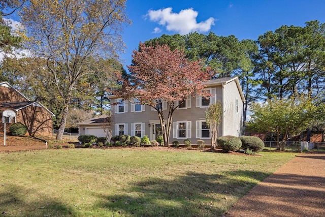 view of front facade featuring a garage and a front lawn