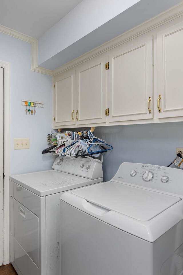 laundry room featuring cabinets and washing machine and dryer