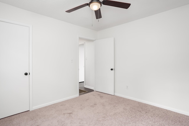 unfurnished bedroom with ceiling fan and carpet flooring