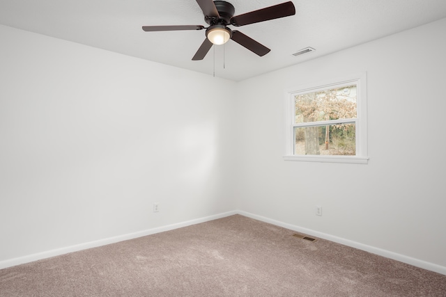 empty room featuring ceiling fan and carpet floors