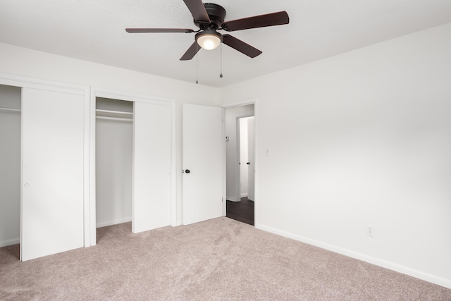 unfurnished bedroom with a closet, ceiling fan, and carpet flooring