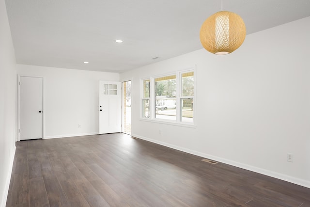 unfurnished room with dark hardwood / wood-style flooring