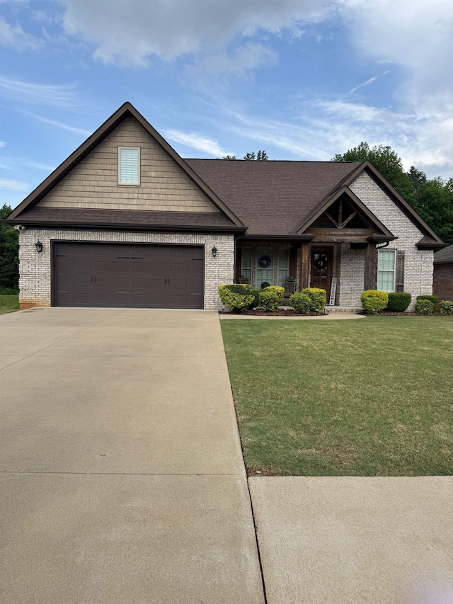 118 Old Orchard Rd, Florence, AL - view of front facade with brick siding, a front lawn, concrete driveway, and an attached garage
