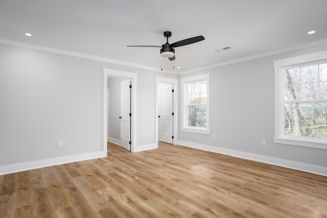 unfurnished bedroom with ceiling fan, crown molding, and multiple windows