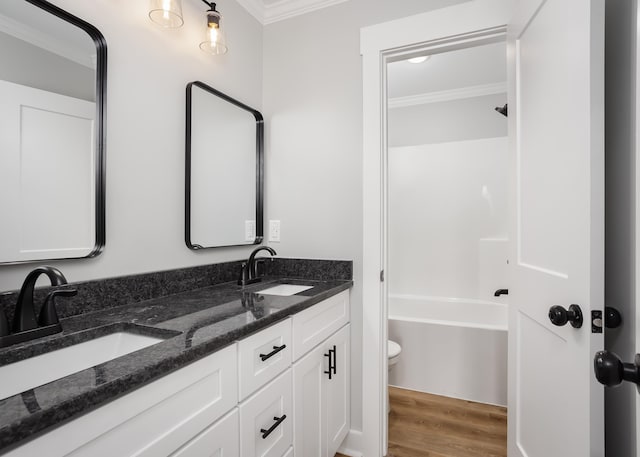 bathroom featuring hardwood / wood-style floors, vanity, toilet, and crown molding