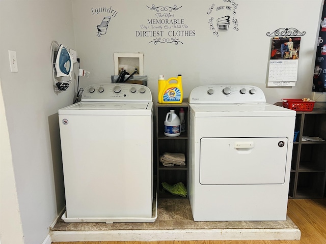 laundry room featuring washer and dryer and light hardwood / wood-style floors