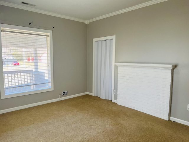 empty room featuring crown molding and light colored carpet