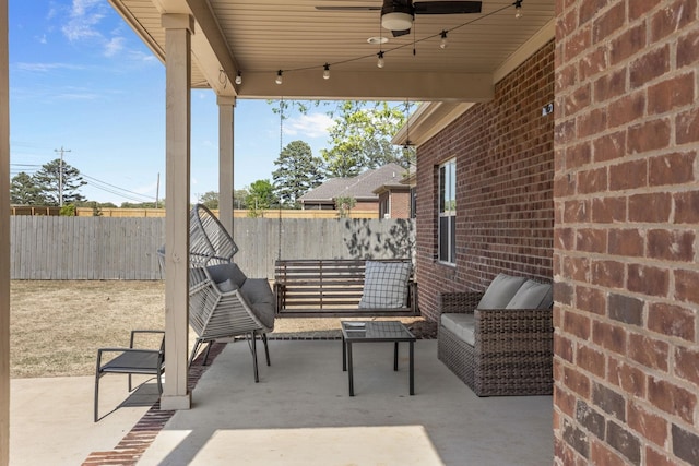 view of patio / terrace with ceiling fan and fence
