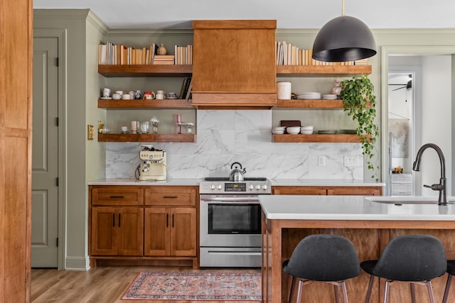 kitchen with light countertops, open shelves, stainless steel electric stove, and a sink