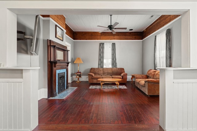 living room featuring ceiling fan and dark hardwood / wood-style flooring