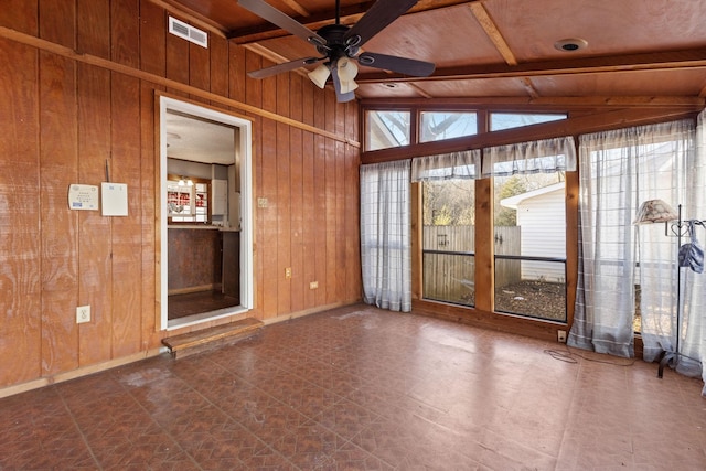 unfurnished sunroom with ceiling fan and vaulted ceiling with beams