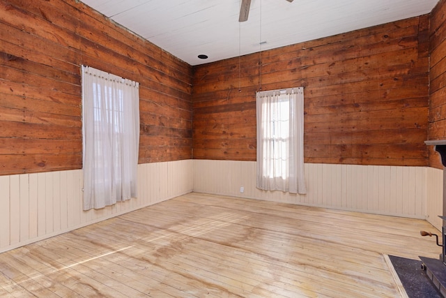 unfurnished room featuring radiator, light hardwood / wood-style flooring, and ceiling fan