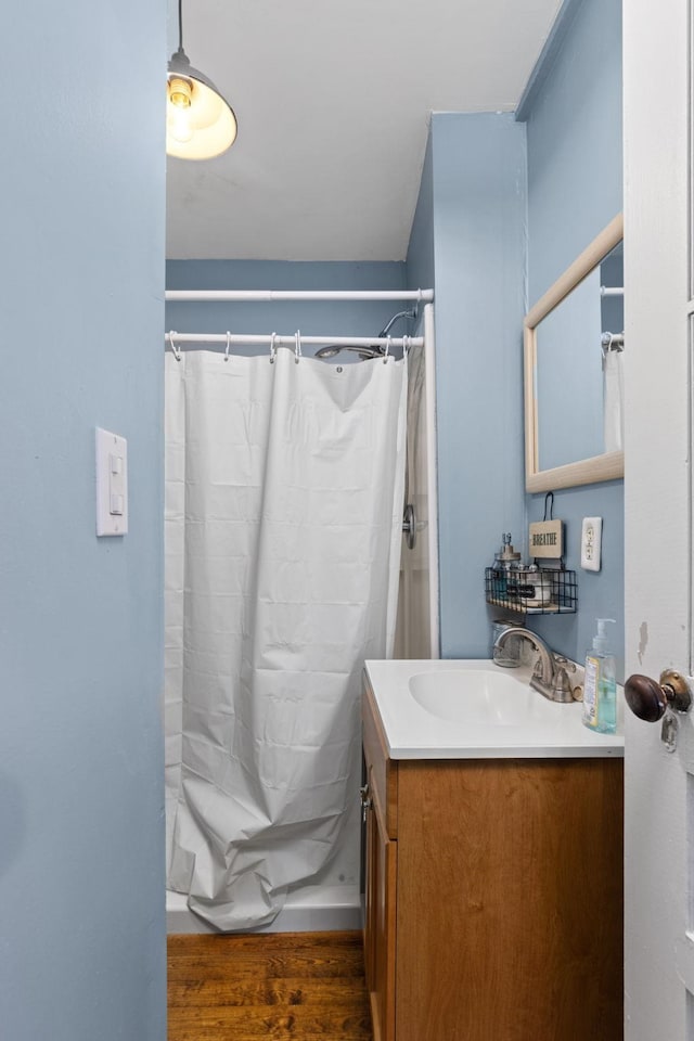 bathroom with vanity, a shower with shower curtain, and hardwood / wood-style floors