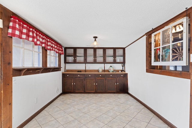 kitchen with light tile patterned flooring and a textured ceiling