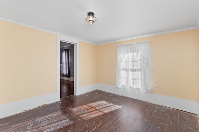 unfurnished room featuring dark wood-type flooring and ornamental molding