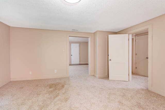  - unfurnished room featuring carpet flooring, a textured ceiling, and baseboards