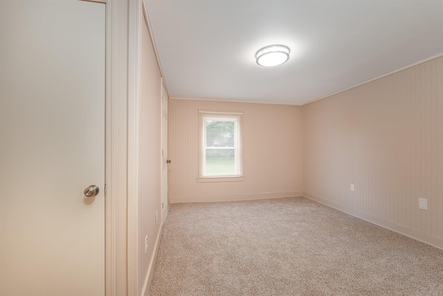  - carpeted empty room with ornamental molding