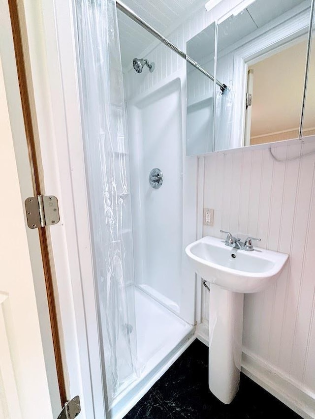 full bathroom featuring a stall shower and a sink