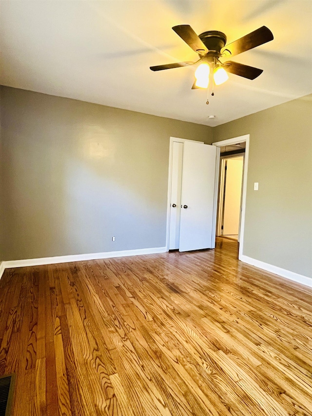 empty room featuring light hardwood / wood-style flooring and ceiling fan