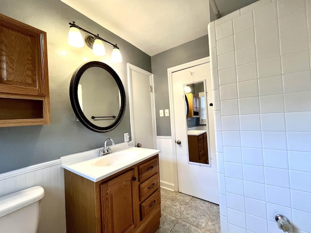 bathroom with tile patterned floors, vanity, and toilet