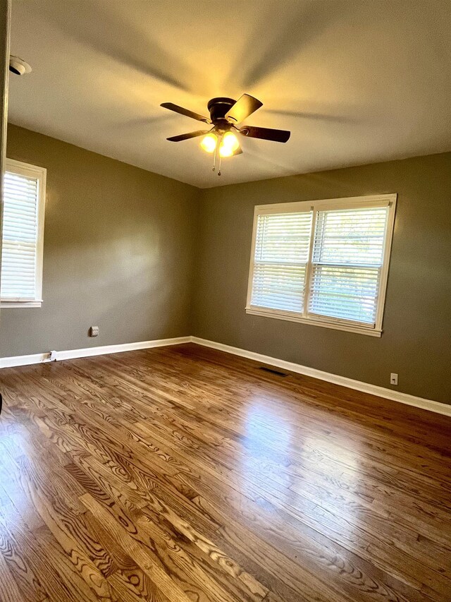 unfurnished room with hardwood / wood-style flooring and ceiling fan