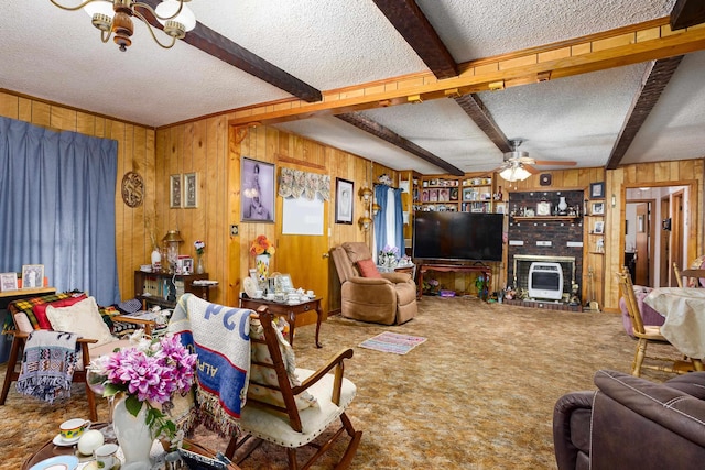 carpeted living room with a textured ceiling, wood walls, beamed ceiling, heating unit, and ceiling fan