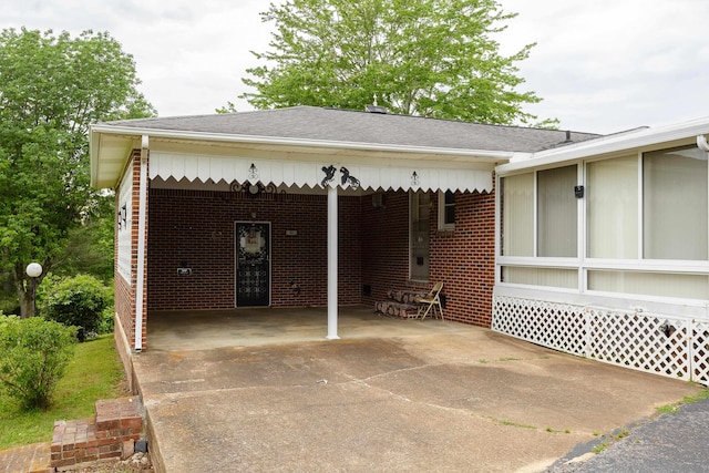 garage featuring driveway and a carport
