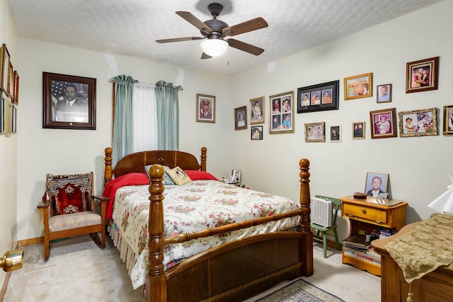 bedroom with light carpet, ceiling fan, and baseboards