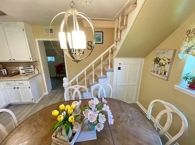 dining area featuring a notable chandelier and light hardwood / wood-style floors