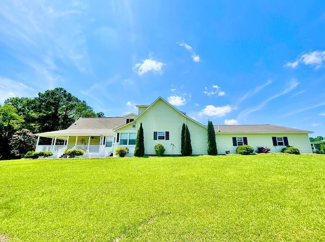 single story home with covered porch and a front yard