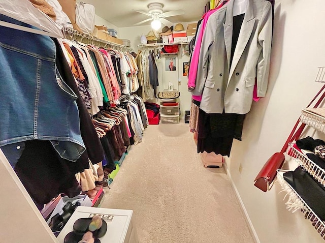 spacious closet with carpet floors and ceiling fan