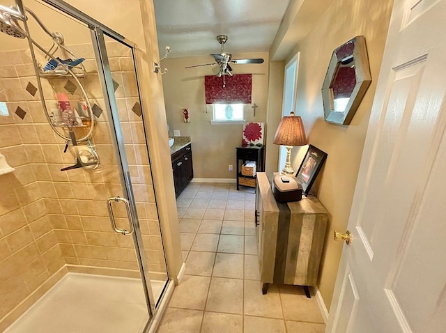 bathroom with ceiling fan, tile patterned flooring, vanity, and a shower with door