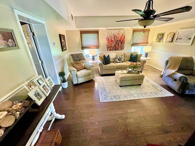 living room featuring a wealth of natural light, ceiling fan, and dark hardwood / wood-style floors