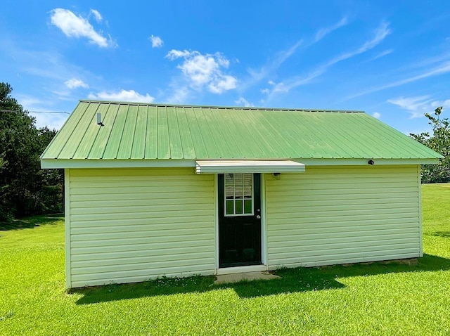 view of outbuilding with a yard