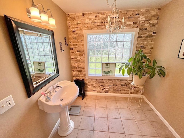 bathroom with tile patterned floors, plenty of natural light, and a chandelier