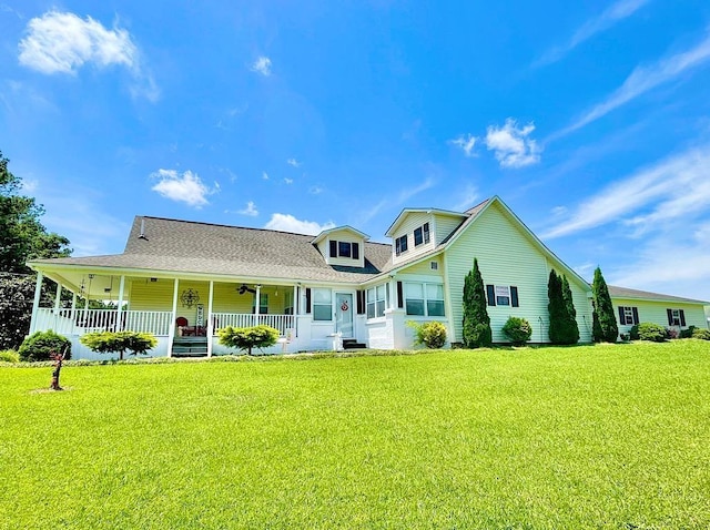 back of property featuring a lawn and a porch