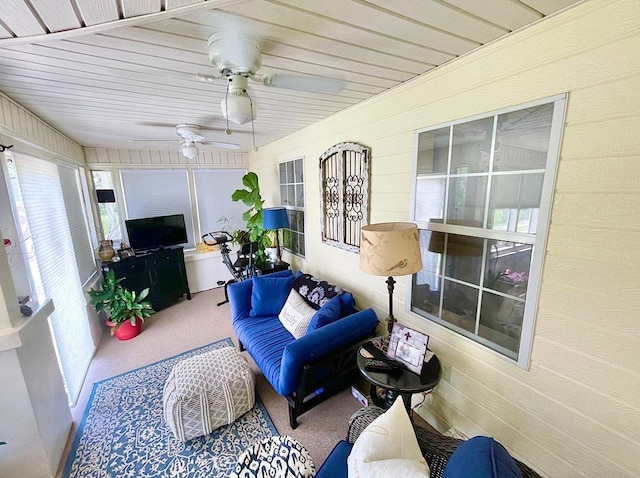 sunroom with ceiling fan and wooden ceiling