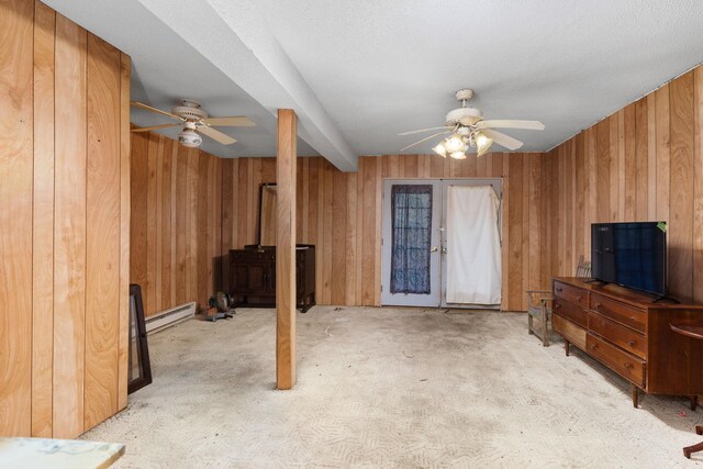 carpeted living room featuring french doors, a textured ceiling, baseboard heating, and ceiling fan