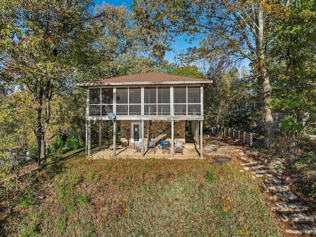 rear view of house with a sunroom and a patio