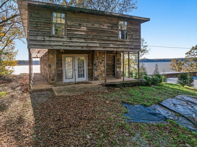 entrance to property with a water view and french doors