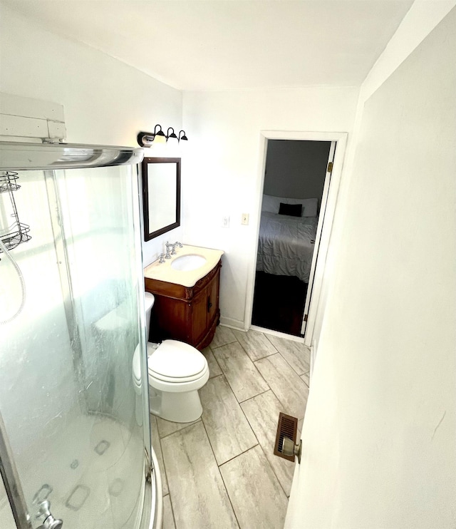 ensuite bathroom featuring vanity, visible vents, ensuite bath, a shower stall, and toilet