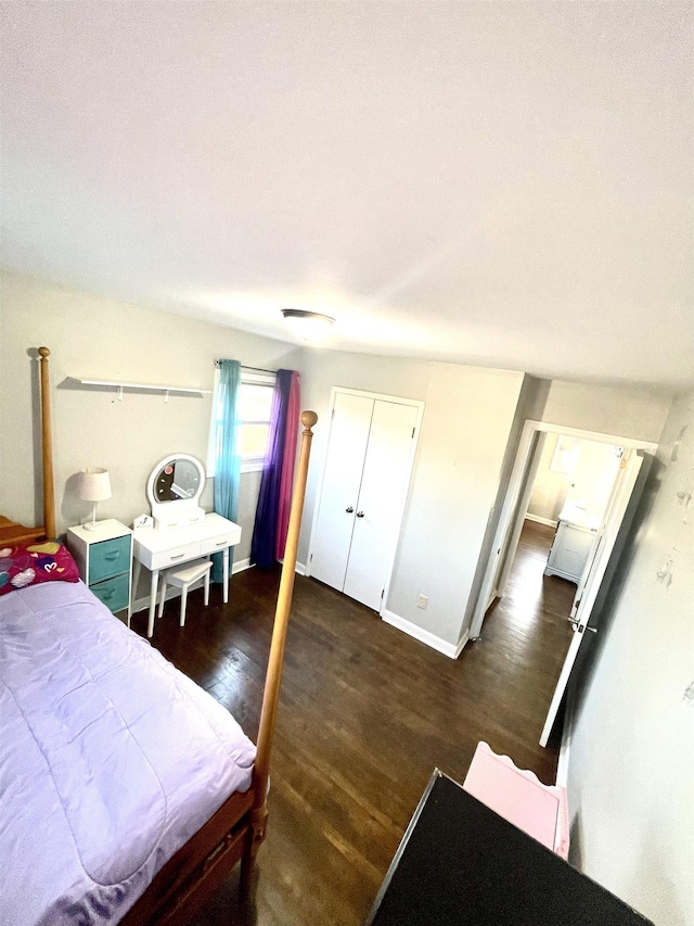 bedroom featuring dark wood finished floors and baseboards