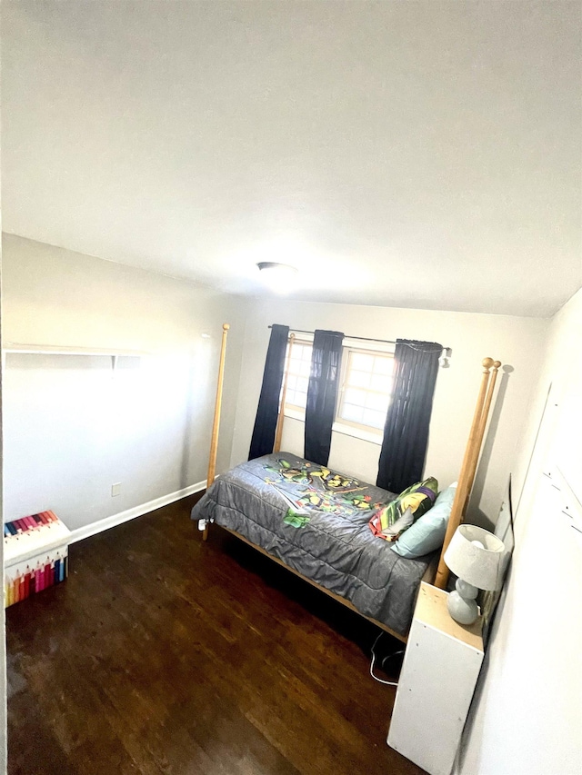 bedroom featuring baseboards and wood finished floors